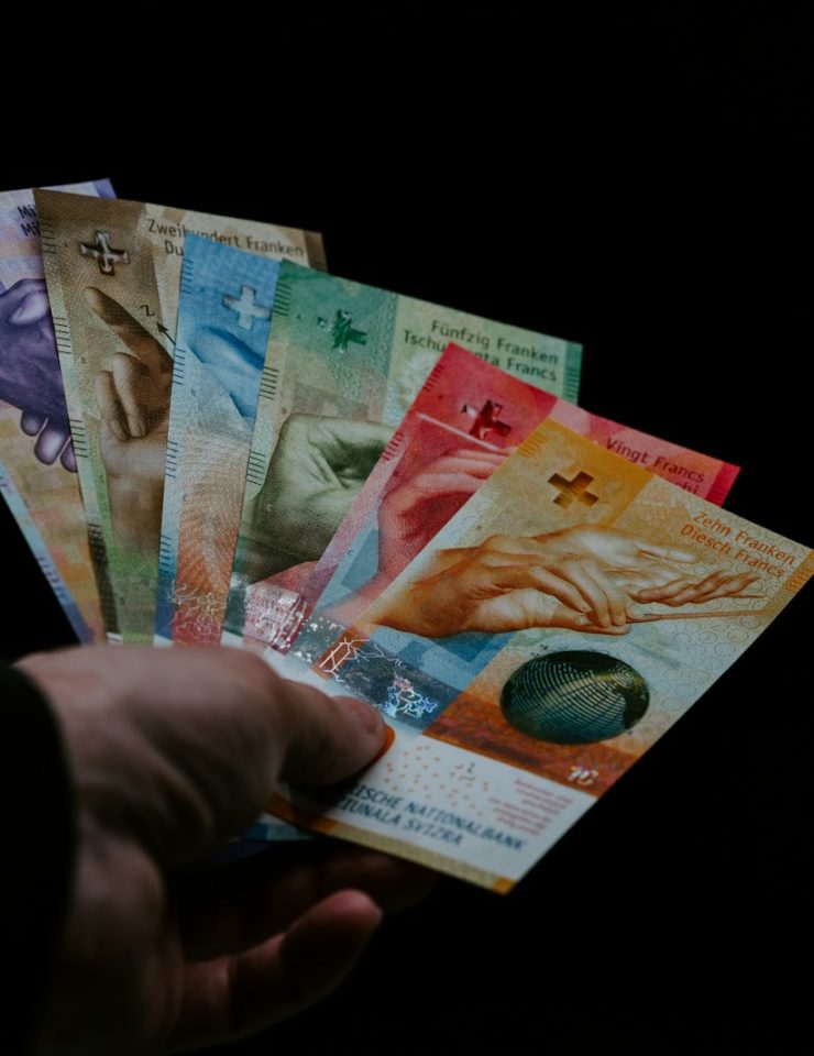 person holding 10 and 20 philippine peso bill